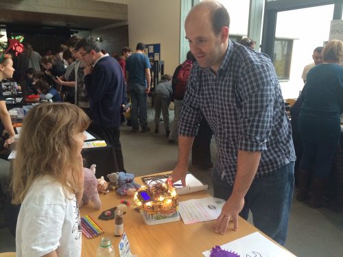 People of all ages take part. Here's Amy, aided by Heffalump and friends, showing Eben her robot.