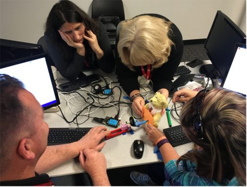 Digital making educators getting hands on with their builds at Picademy
